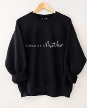 Load image into Gallery viewer, black sweater featuring the slogan tired as a mother in white 
