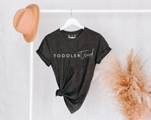 Load image into Gallery viewer, dark grey t-shirt featuring toddler tired slogan in white
